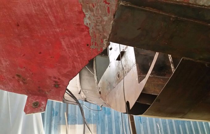 With the prop shaft now removed I've started to remove the final area of rusty steel leading from the shaft to the transom. It will need all new beams. Still a very big job.